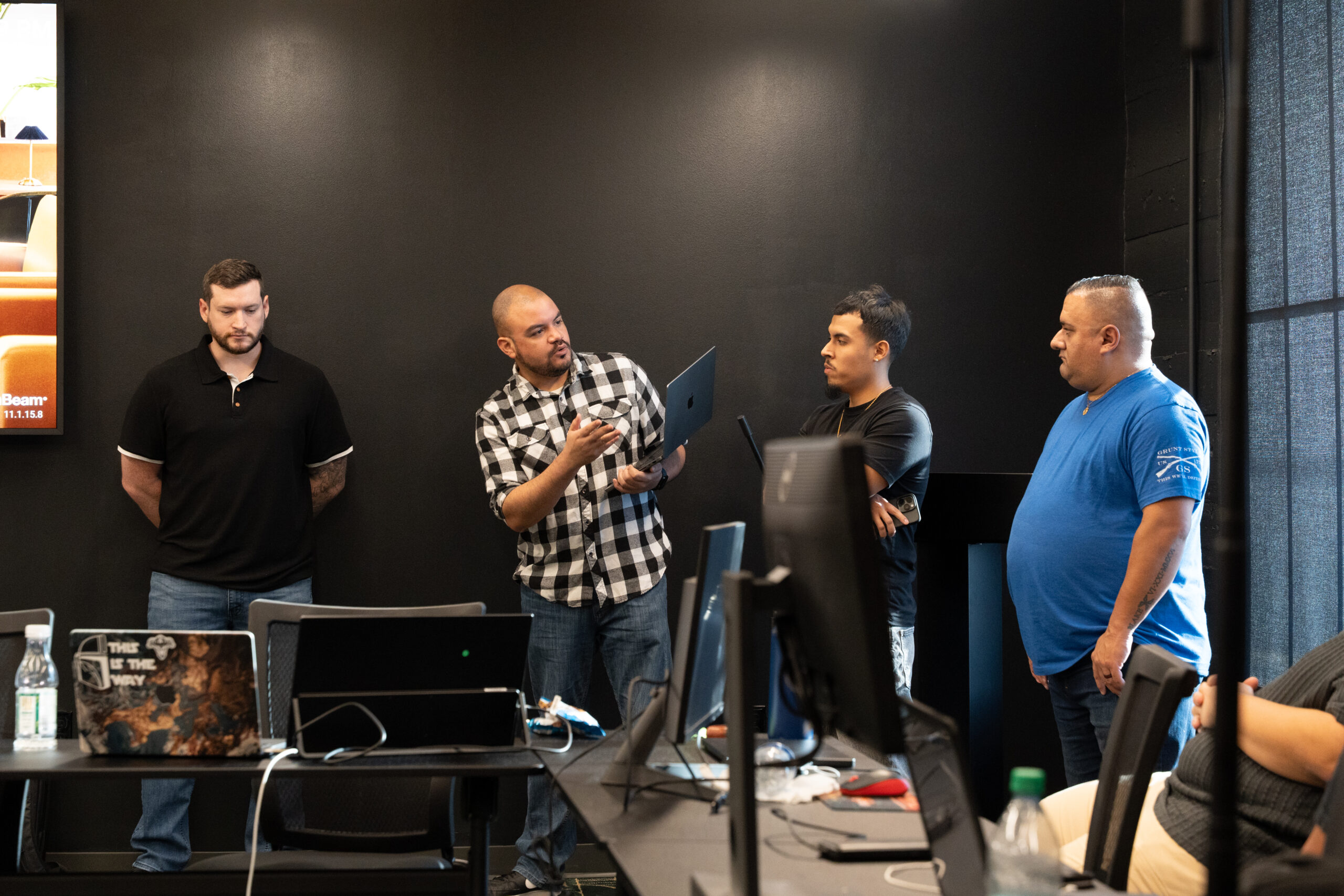 Five people sitting around a table for a brainstorming session.